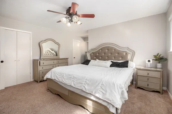 a bedroom with a bed and a chandelier