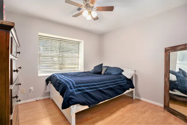 a bed sitting in a bedroom next to a window