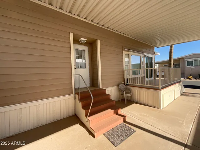 a view of a two chairs in the patio