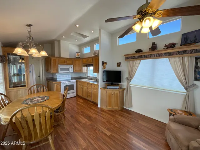 a living room with furniture a chandelier and a flat screen tv