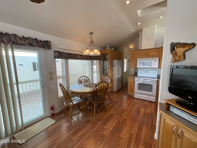 a dining room with furniture and wooden floor