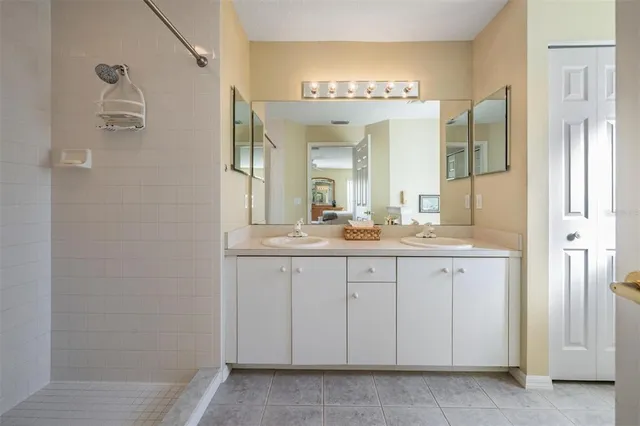 a spacious bathroom with a double vanity sink and a mirror