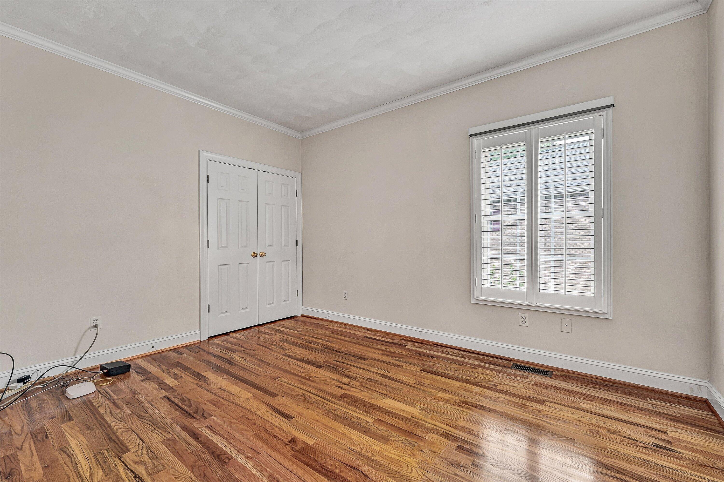 131 Stoney Mill Road Rocky Mount, VA 24151 - Photo 18 of 37 a view of an empty room with wooden floor and a window