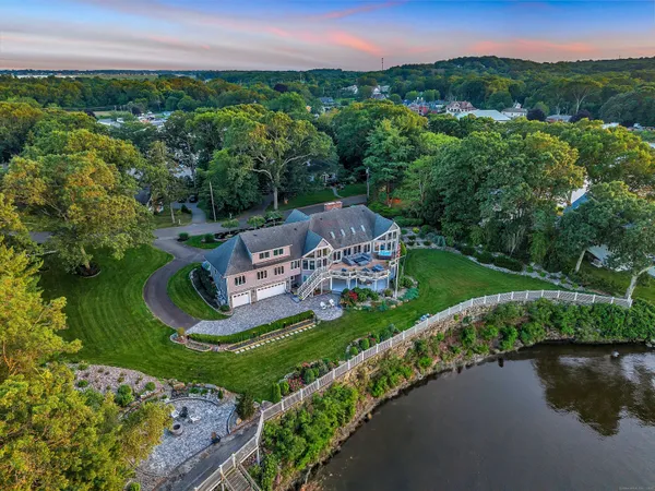 an aerial view of a house with a garden and lake view