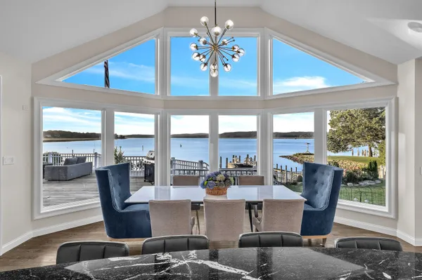 a living room with furniture and large windows