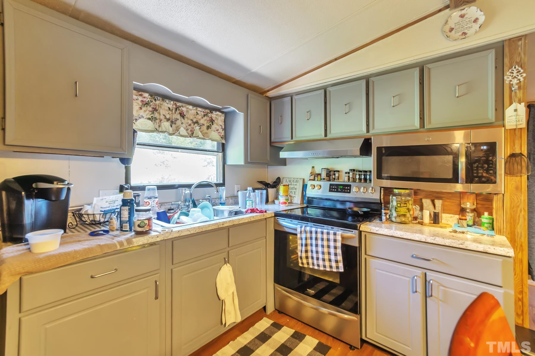 720 Whitley Road Middlesex, NC 27557 - Photo 13 of 25 a kitchen with stainless steel appliances white cabinets sink and a window