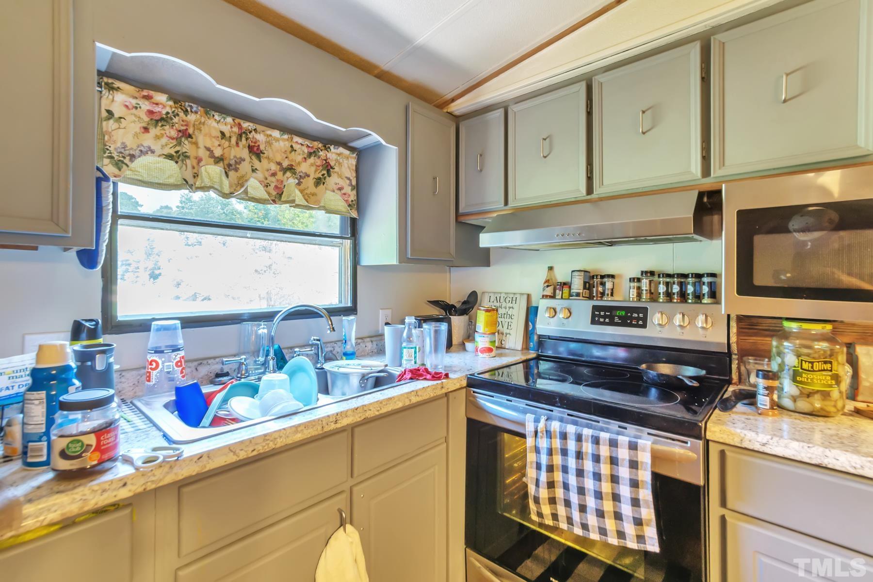 720 Whitley Road Middlesex, NC 27557 - Photo 14 of 25 a kitchen with stainless steel appliances a sink stove and window