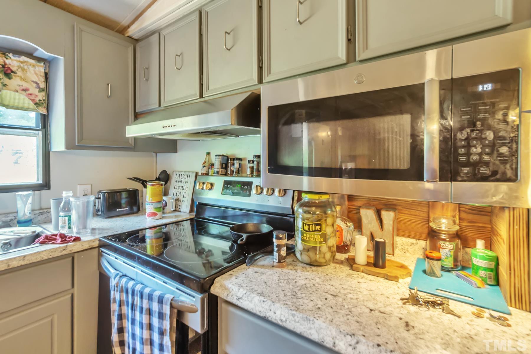720 Whitley Road Middlesex, NC 27557 - Photo 15 of 25 a kitchen that has a sink and a stove in it