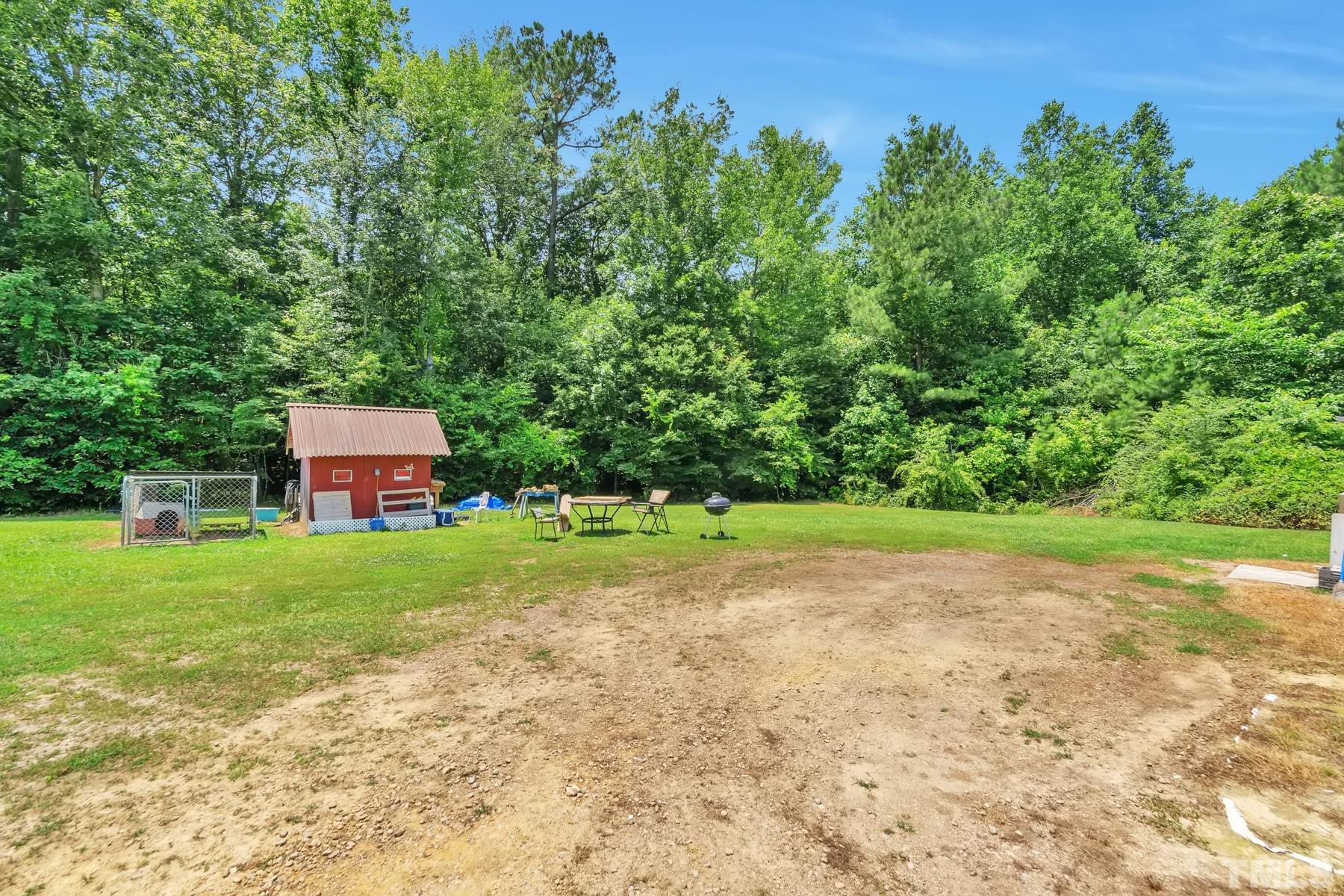 720 Whitley Road Middlesex, NC 27557 - Photo 4 of 25 a view of a yard with a house in the background