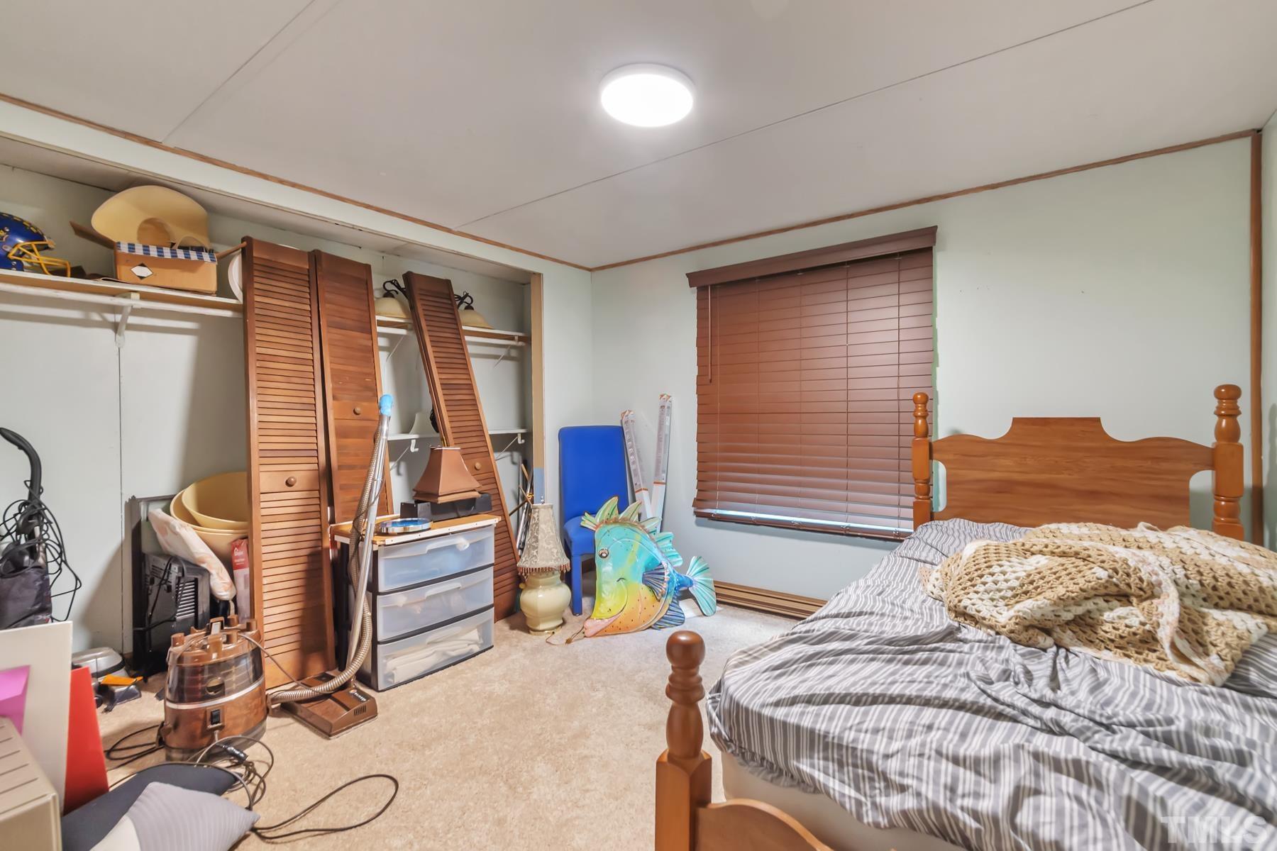 720 Whitley Road Middlesex, NC 27557 - Photo 7 of 25 a bedroom with a bed and wooden floor