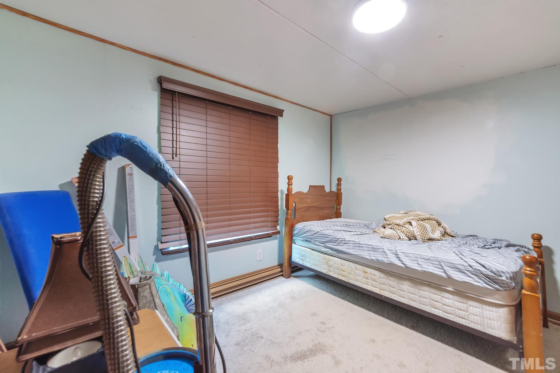 720 Whitley Road Middlesex, NC 27557 - Photo 8 of 25 a bedroom with bed and a window
