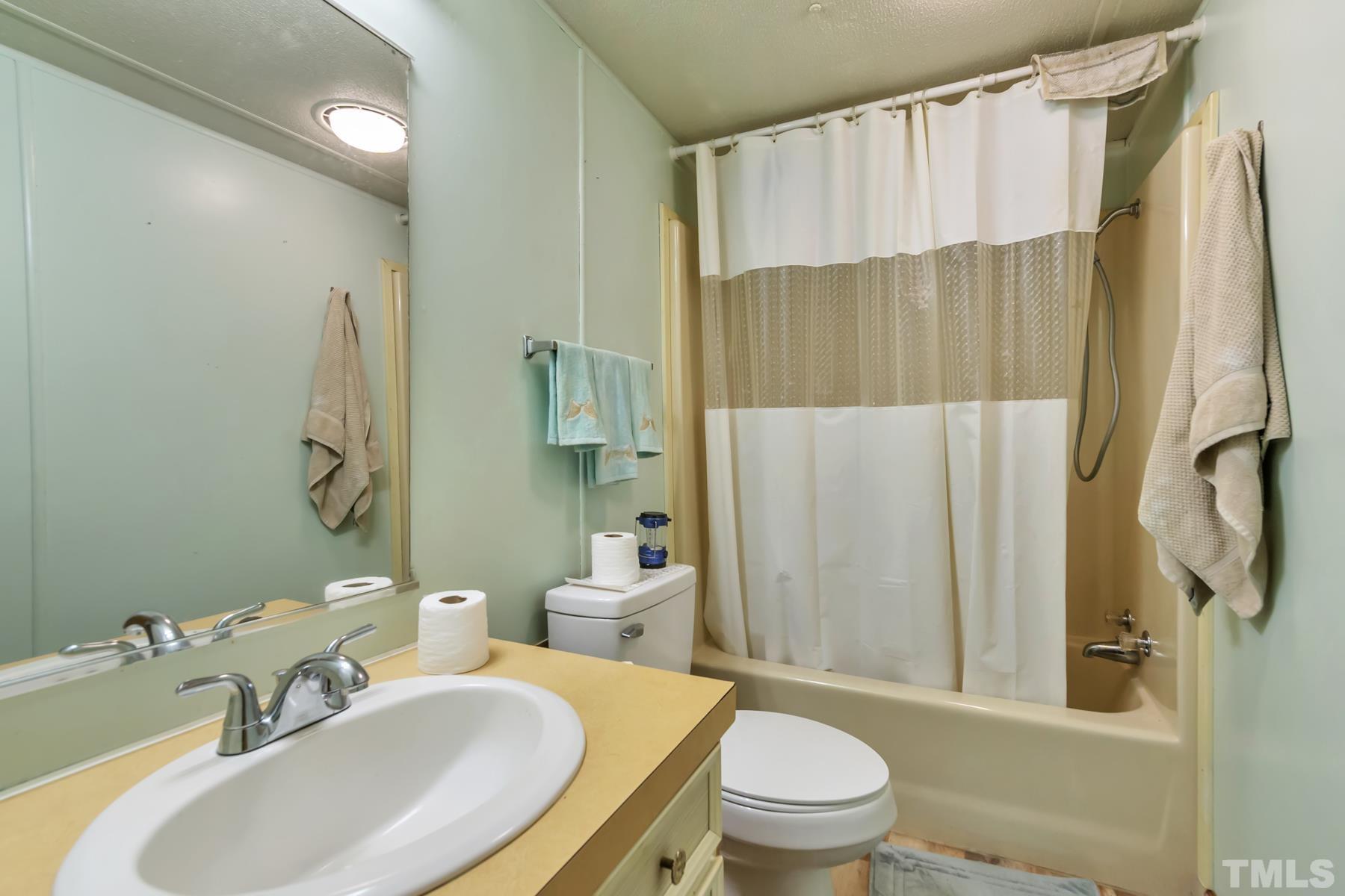 720 Whitley Road Middlesex, NC 27557 - Photo 9 of 25 a bathroom with a sink toilet and shower