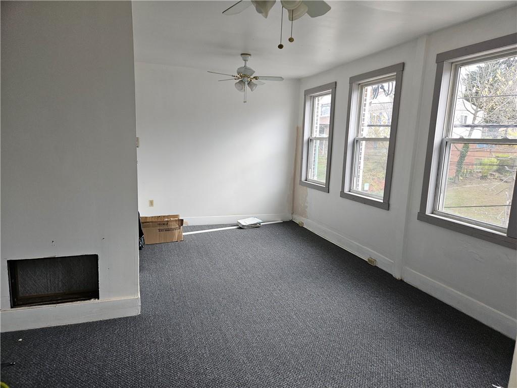 2215 Ardmore Boulevard Forest Hills, PA 15221 - Photo 3 of 8 an empty room with windows and chandelier fan