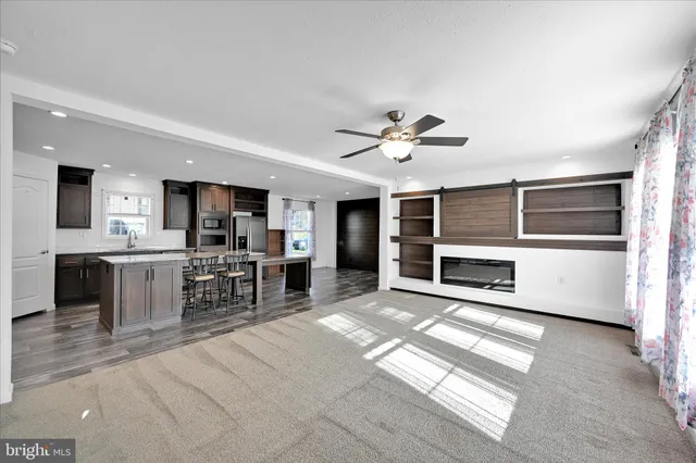 a view of a kitchen with microwave and refrigerator