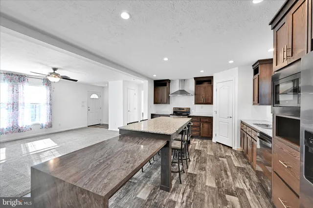 a large kitchen with a table and chairs in it