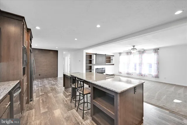 a kitchen with kitchen island a sink table and chairs