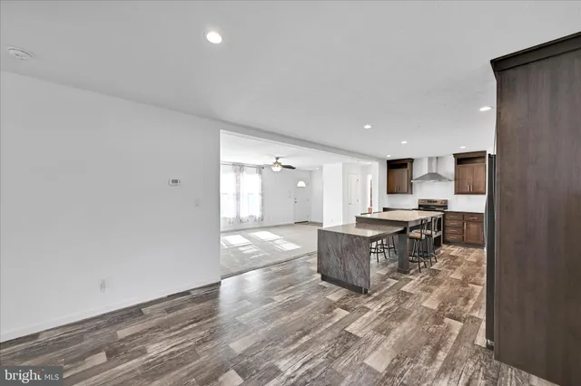 a large kitchen with a counter space a sink and stainless steel appliances