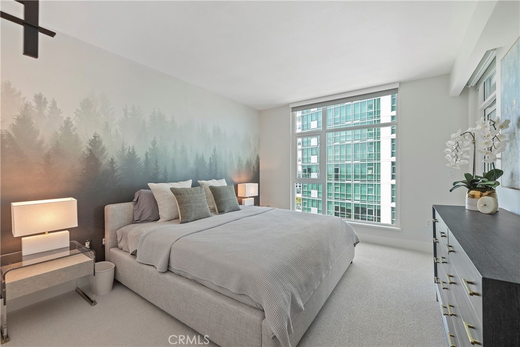 3141 Michelson Drive, Unit 907 Irvine, CA 92612 - Photo 16 of 48 a bed room with a bed and a chair