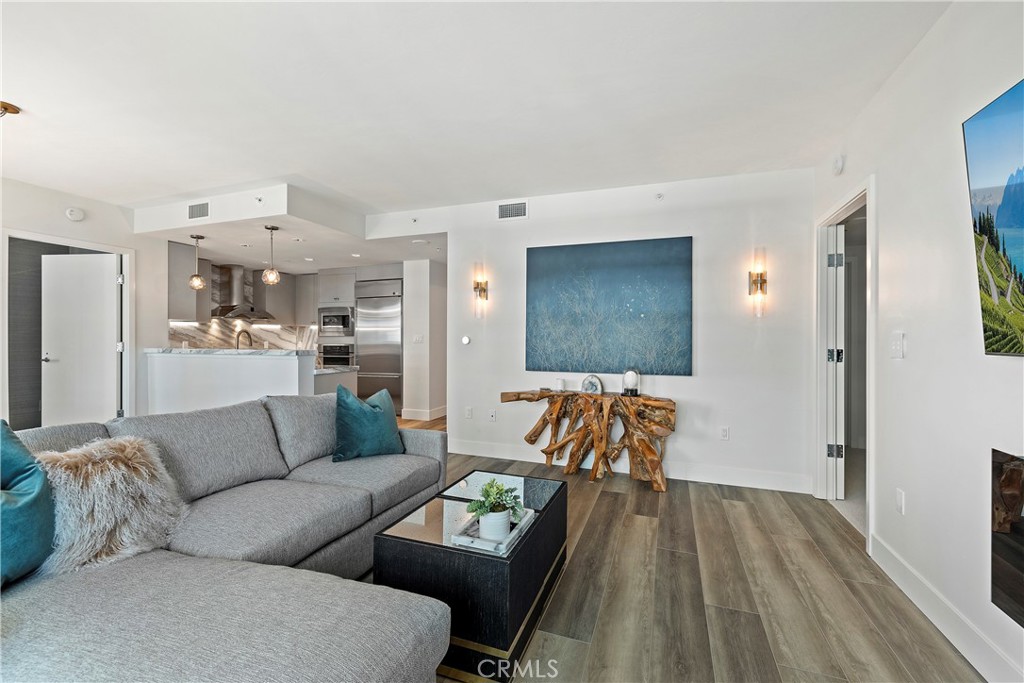 3141 Michelson Drive, Unit 907 Irvine, CA 92612 - Photo 2 of 48 a living room with furniture and kitchen view