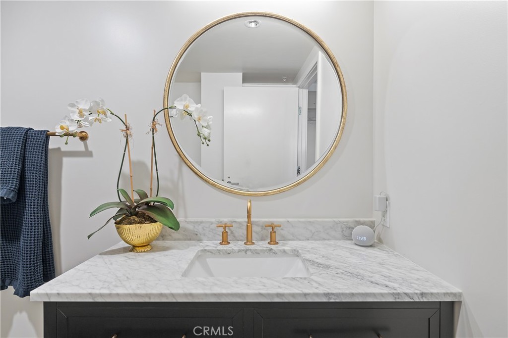 3141 Michelson Drive, Unit 907 Irvine, CA 92612 - Photo 28 of 48 a bathroom with a sink and a mirror