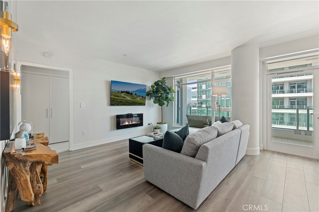 3141 Michelson Drive, Unit 907 Irvine, CA 92612 - Photo 3 of 48 a living room with fireplace furniture and a large window