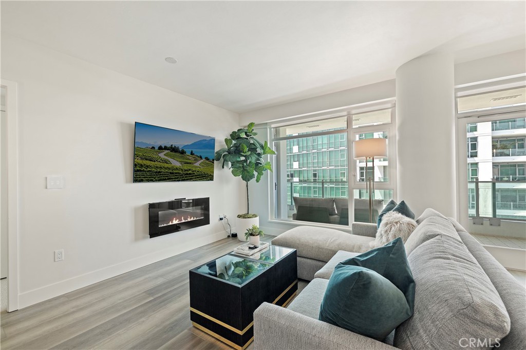 3141 Michelson Drive, Unit 907 Irvine, CA 92612 - Photo 4 of 48 a living room with furniture flat screen tv and a fireplace
