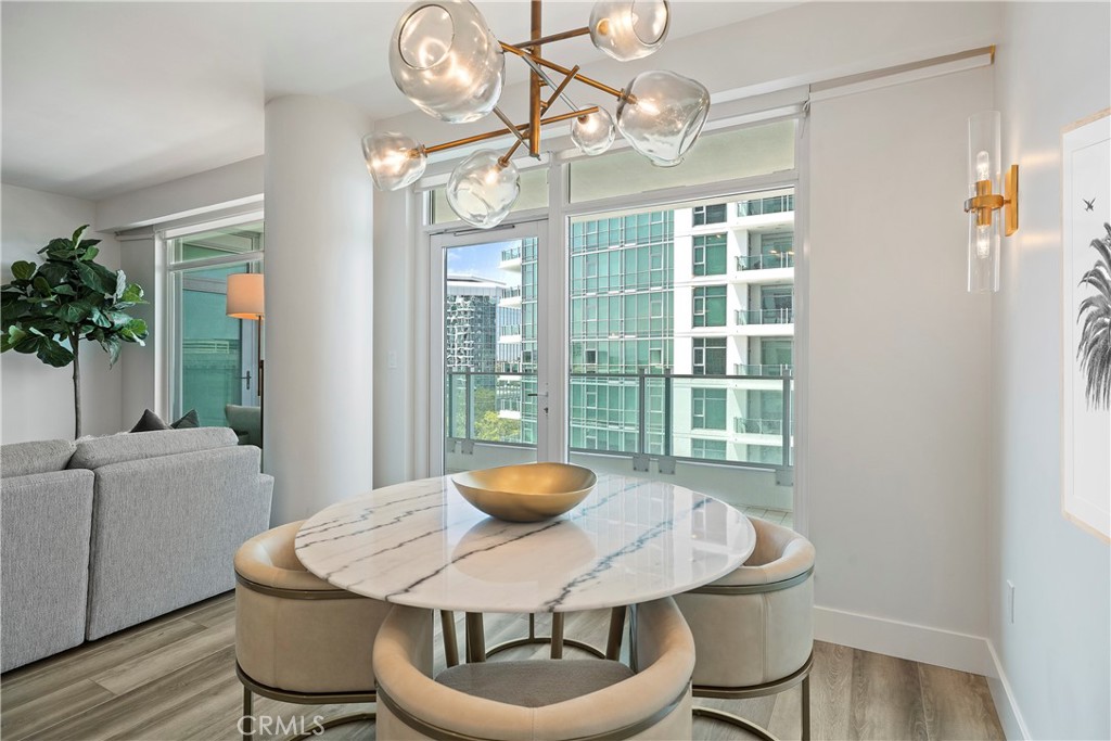 3141 Michelson Drive, Unit 907 Irvine, CA 92612 - Photo 5 of 48 a dining room with furniture a large window and a chandelier