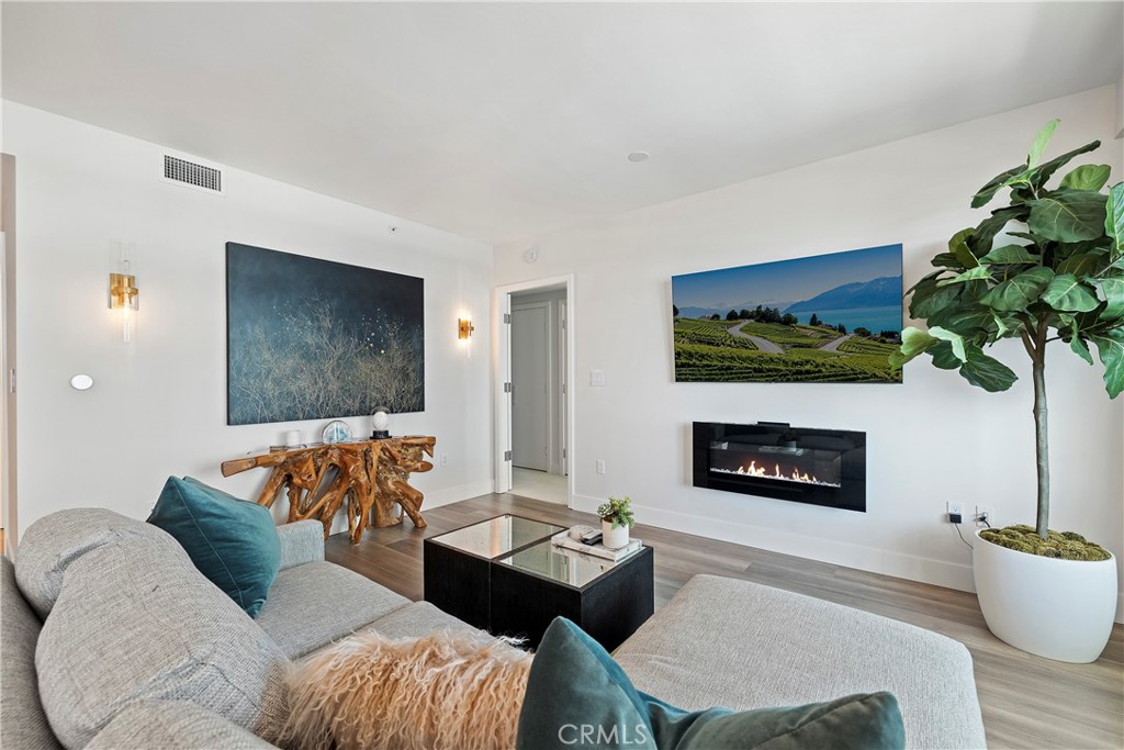 3141 Michelson Drive, Unit 907 Irvine, CA 92612 - Photo 6 of 48 a living room with furniture and a fireplace