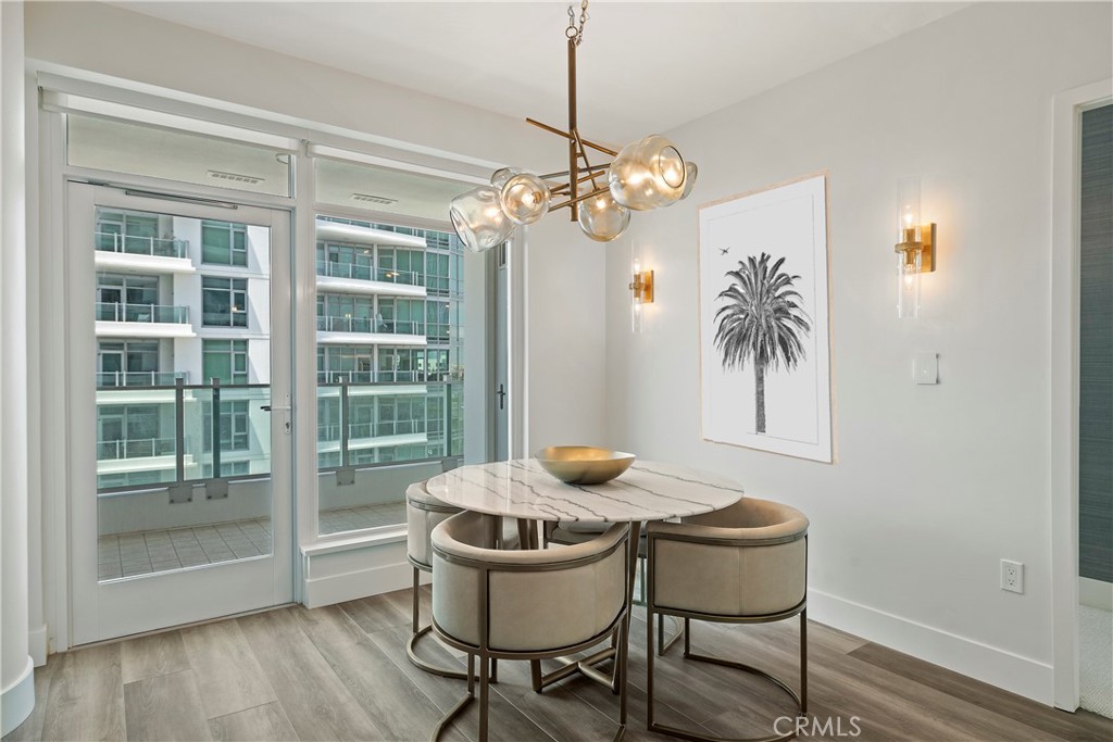 3141 Michelson Drive, Unit 907 Irvine, CA 92612 - Photo 8 of 48 a dining room with furniture a chandelier and wooden floor