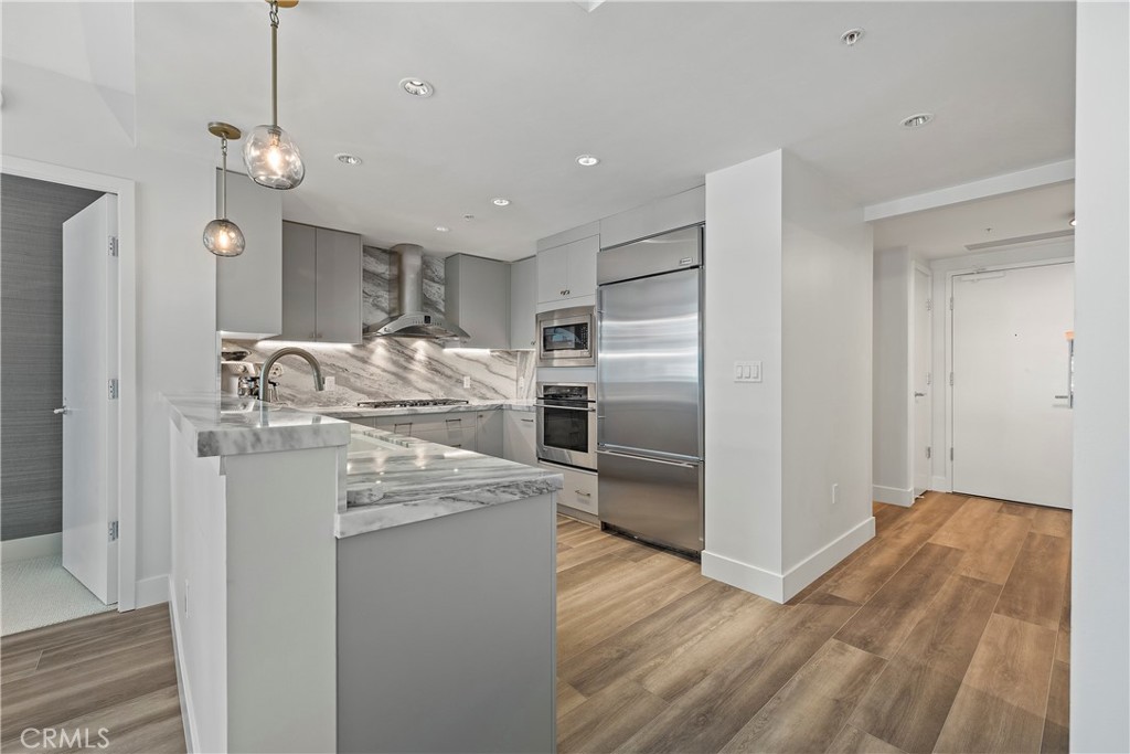 3141 Michelson Drive, Unit 907 Irvine, CA 92612 - Photo 10 of 48 a kitchen with kitchen island a counter top space cabinets and stainless steel appliances