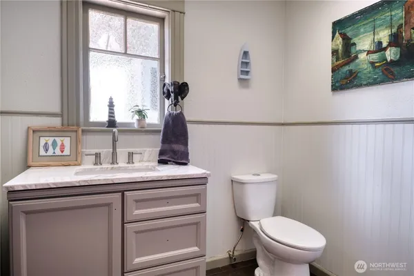 a bathroom with a toilet sink and window