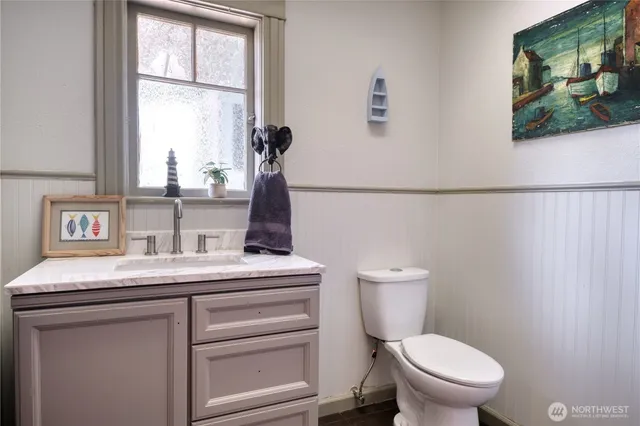 a bathroom with a toilet sink and window