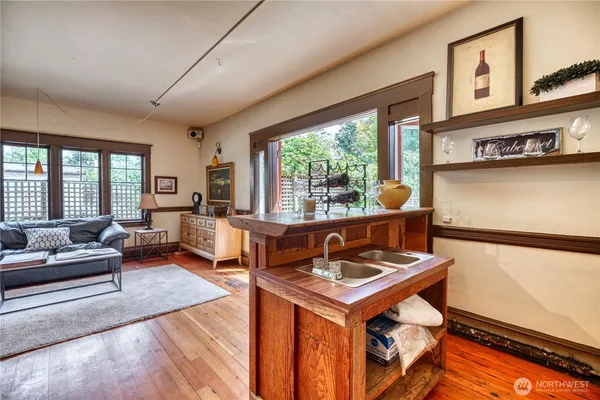a living room with furniture and a floor to ceiling window