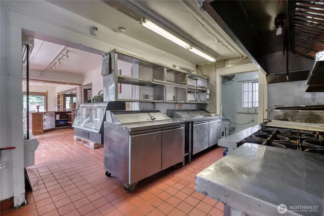 a kitchen with stainless steel appliances granite countertop a stove and a refrigerator
