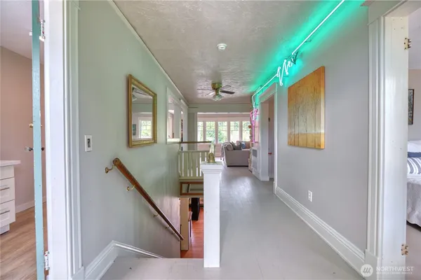 a view of entryway and hall with wooden floor