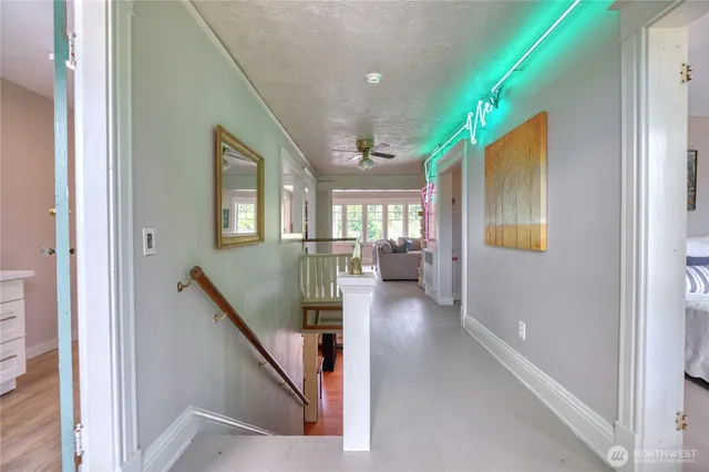 a view of entryway and hall with wooden floor
