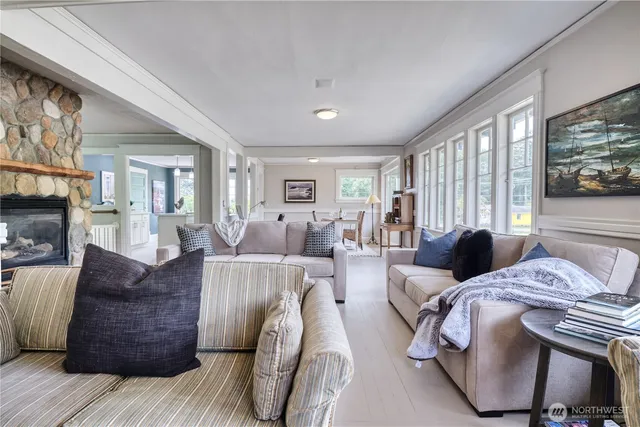 a living room with furniture a large window and flat screen tv