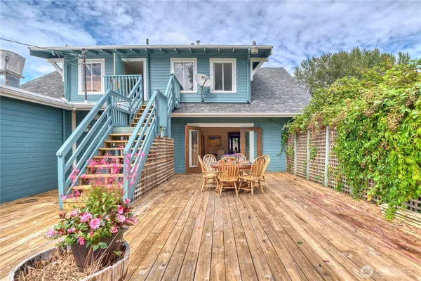 a view of a house with a patio and a garden