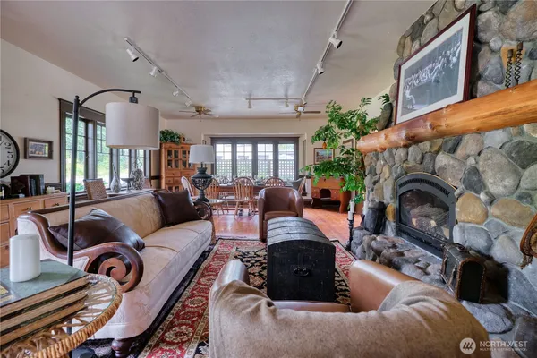 a living room with furniture a fireplace and potted plants