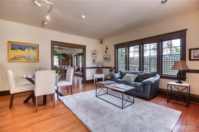 a living room with furniture and a wooden floor