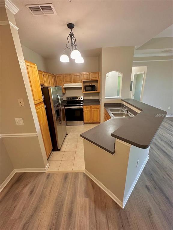 3280 Soho Street, Unit 307 Orlando, FL 32835 - Photo 8 of 34 a kitchen with stainless steel appliances granite countertop a sink stove and refrigerator