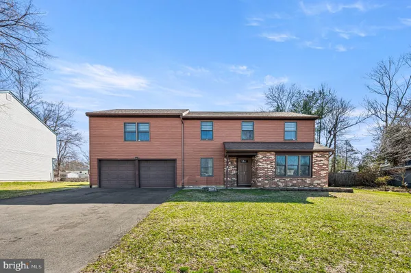 a front view of a house with a yard and balcony