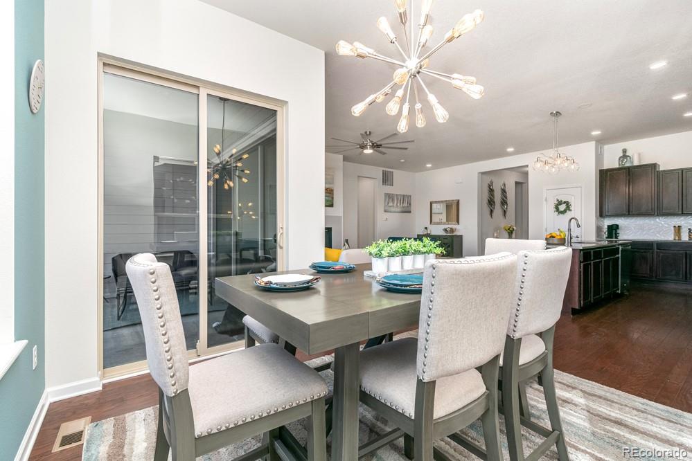 2944 Zephyr Road Fort Collins, CO 80528 - Photo 12 of 35 a view of a dining room with furniture and a chandelier