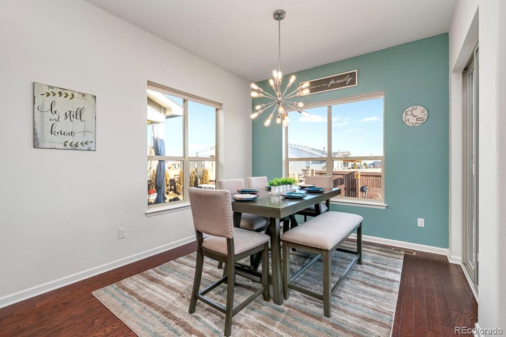 2944 Zephyr Road Fort Collins, CO 80528 - Photo 13 of 35 a view of a dining room with furniture window and wooden floor