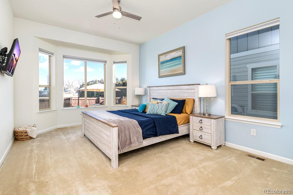 2944 Zephyr Road Fort Collins, CO 80528 - Photo 18 of 35 a spacious bedroom with a bed and a large window
