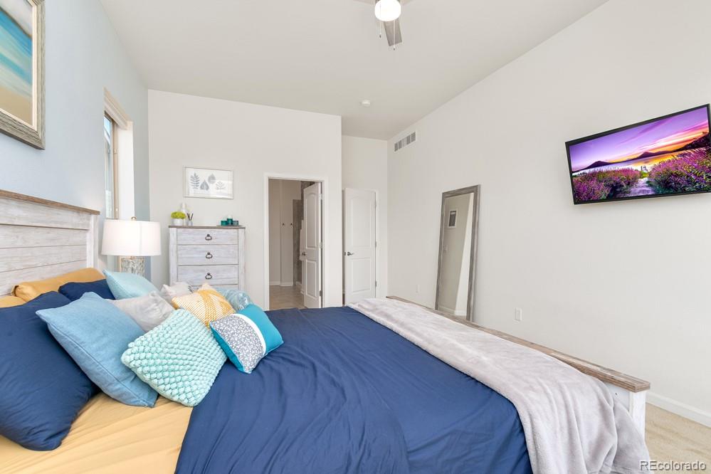 2944 Zephyr Road Fort Collins, CO 80528 - Photo 20 of 35 a bedroom with a bed and a couch