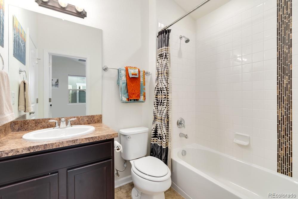 2944 Zephyr Road Fort Collins, CO 80528 - Photo 29 of 35 a bathroom with a granite countertop sink toilet and shower