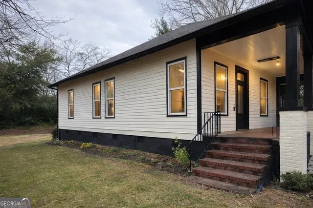 a front view of a house with a garden