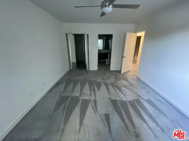 a view of a room with wooden floor and an entryway