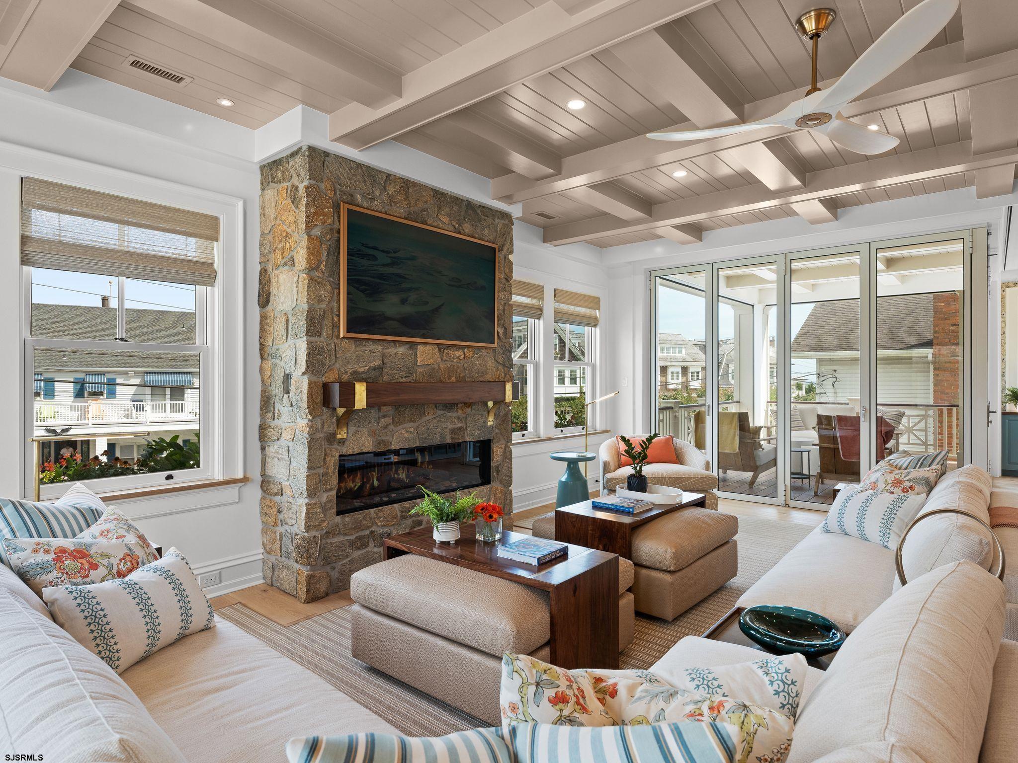 12 East Newcastle Road Ocean City, NJ 08226 - Photo 19 of 99 a living room with furniture a flat screen tv and a large window
